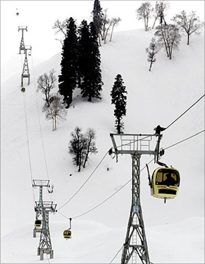 Foreign skiers travel in cable car gondolas in Gulmarg.
