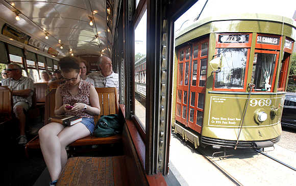 Julie Botnick of New Haven, Connecticut, uses her smartphone as she travels down the St Charles Avenue Street Car line in New Orleans, United States.