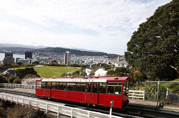 Wellington Cable Car ascends with a view of the city in the background.