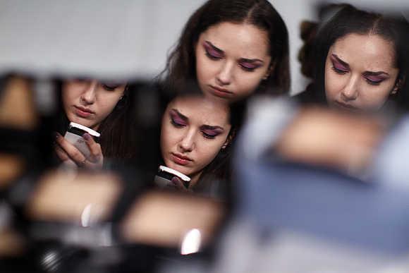 A model looks at her mobile phone in New York City.