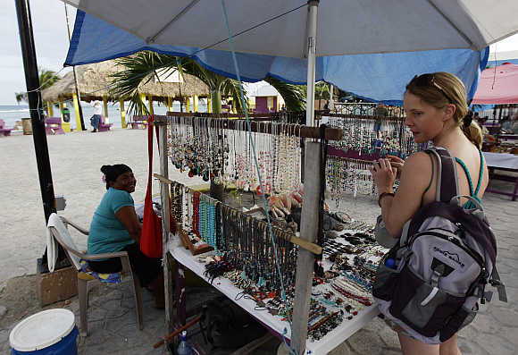 A tourist looks at handicrafts on the main square in San Pedro, Belize.