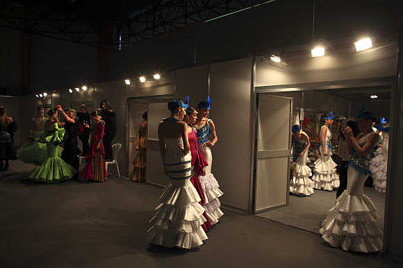 Models are seen backstage before the start of a fashion show in the Andalusian capital of Seville, Spain.