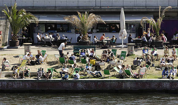 People enjoy a sunny day at river Spree in Berlin's Mitte (Centre) district, Germany.
