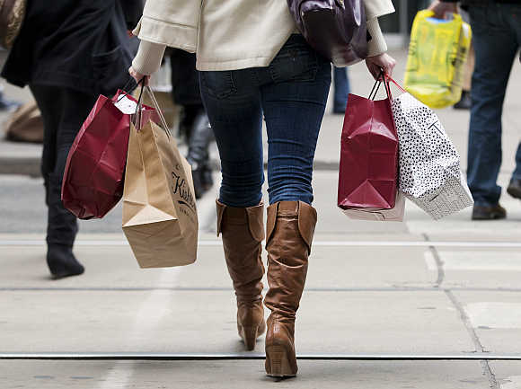 A woman carries shopping bags during the Christmas season in Toronto, Canada.
