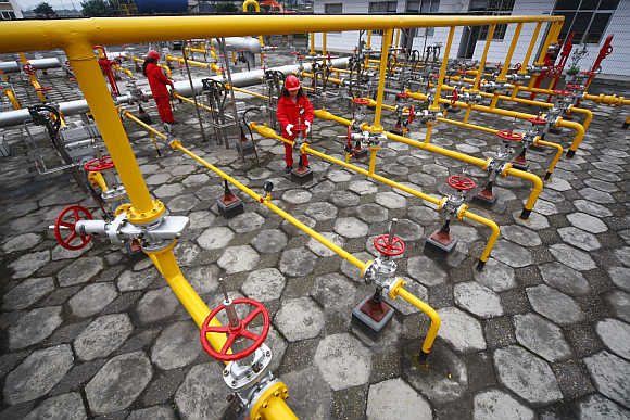 Employees of China National Petroleum Corporation carry out routine checks at a gas refinery in Suining, Sichuan province, China.