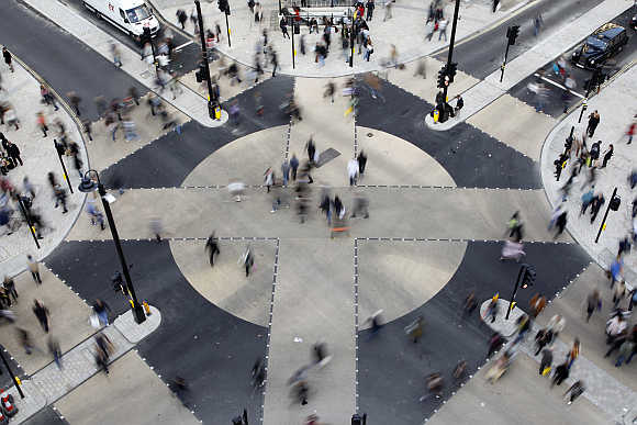 Pedestrian cross the diagonal crossing at Oxford Circus in London.