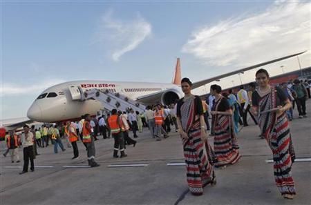 This file photograph shows air hostesses walk next to the parked Air India's Boeing 787-800 Dreamliner upon its arrival at the airport in New Delhi.