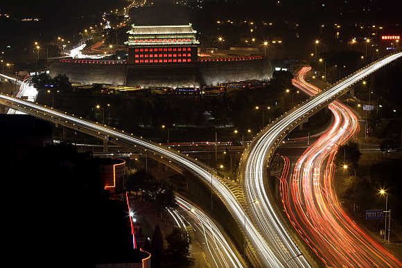 Deshengmen Embrasure Watchtower is lit by coloured lights in Beijing, China.
