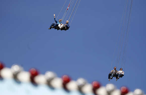 People enjoy a ride on a swing carousel at Prater amusement park in Vienna, Austria.