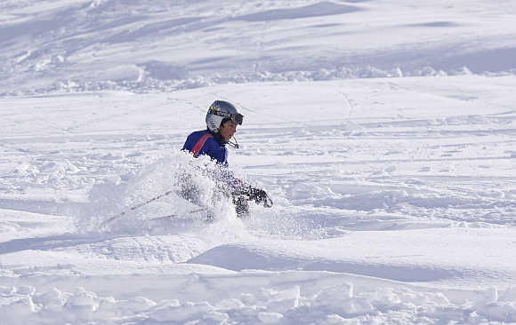 A boy learns to ski fresh powder at the Shemshak ski resort, 30km north of Tehran, Iran.