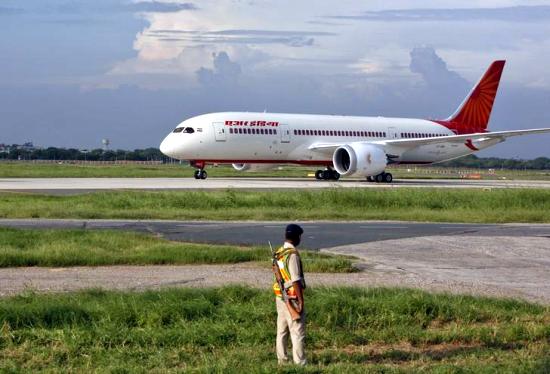 A security personnel stands guard as Air India's Dreamliner Boeing 787 taxies upon its arrival at the airport in New Delhi.