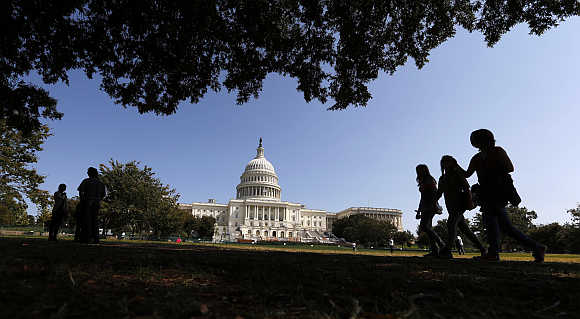 Tourists stroll in front of the US Capitol in Washington, DC, United States.