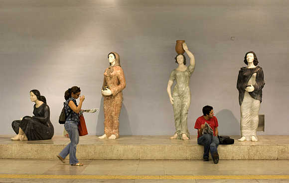Passengers wait for their trains at Lisbon's subway station in Portugal.