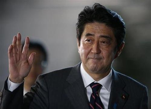 Japan's Prime Minister Shinzo Abe waves as he arrives at his official residence in Tokyo.