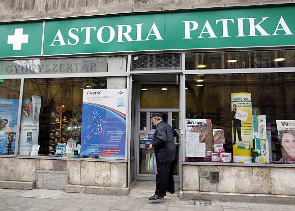 A man exits a pharmacy in downtown Budapest, Hungary.