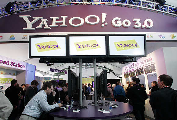 People look over displays at the Yahoo! booth during the Consumer Electronics Show in Las Vegas, Nevada.