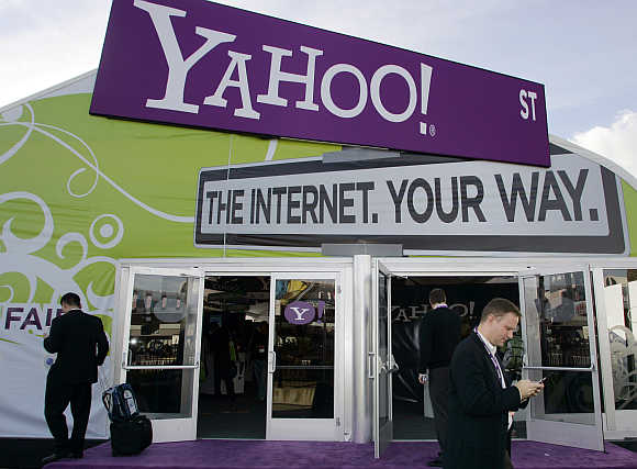A man checks his mobile phone outside the Yahoo! booth during the Consumer Electronics Show in Las Vegas, Nevada.