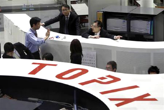 Employees of the Tokyo Stock Exchange work at the bourse.