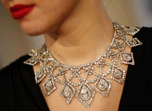 A model wears a diamond necklace by Cartier, estimated at $412,777 - 515,923, in London.