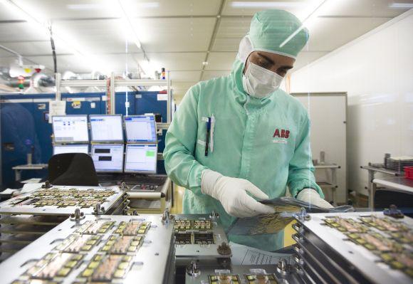 An employee works on the production of high-power semiconductors at a manufacturing plant.