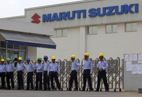 Private security guards stand outside the main entrance to the Maruti Suzuki India Limited plant in Manesar.