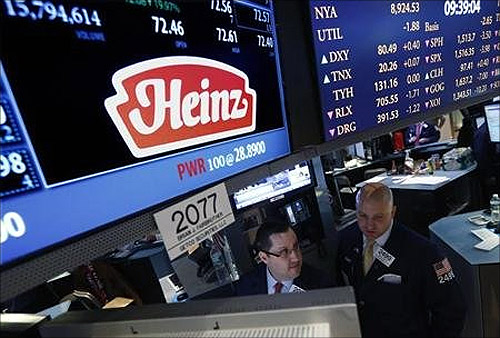 Traders work at the post that trades H.J. Heinz Co. on the floor of the New York Stock Exchange.