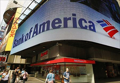 Tourists walk past a Bank of America banking center in Times Square in New York.