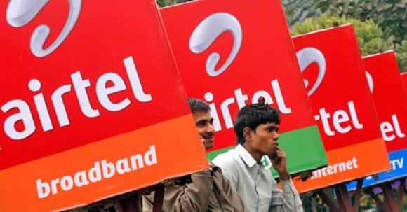 Bharti Airtel billboards along a sidewalk in Kolkata.