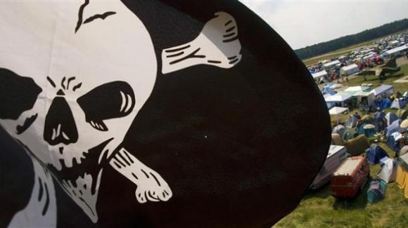 A skull flag waves over the