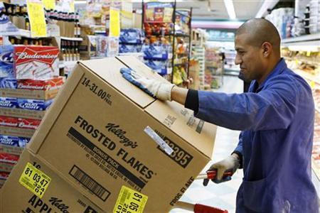 A store employee moves boxes full of of Kellogg's cereal in a supermarket in New York.