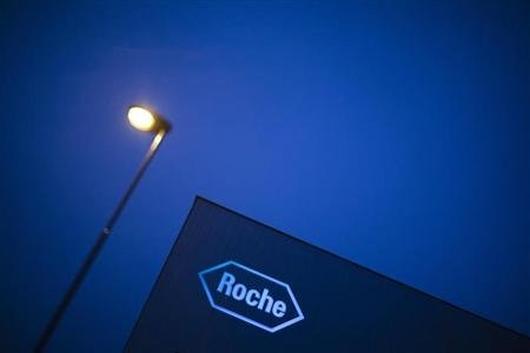 A logo of Swiss pharmaceutical company Roche is pictured in front of a company's building in Rotkreuz.