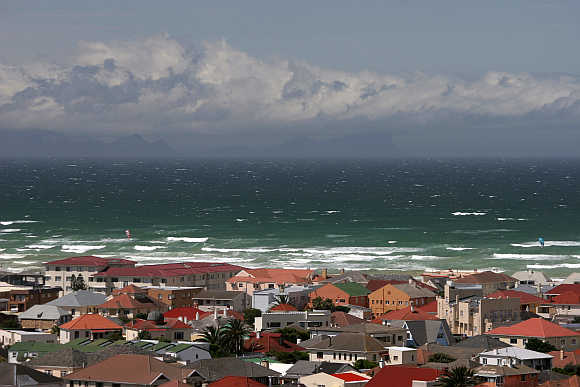 Waves crash the shoreline of Muizenberg, a suburb of Cape Town, in South Africa.