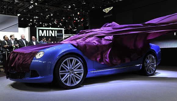The wrap comes off the Bentley Continental GT Speed Convertible as it is unveiled at the North American International Auto Show in Detroit, Michigan.