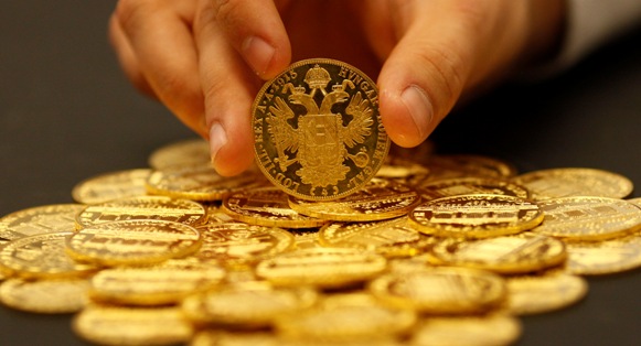 An employee sorts cold coins in the Austrian auction house Dorotheum in Vienna.