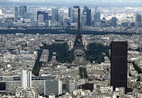 The Eiffel tower, la Defence business district (background) and the Montparnasse tower (R) are seen in an aerial view in Paris.