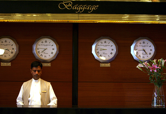 An employee stands behind the luggage counter.