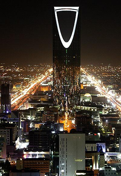 Kingdom Tower stands in the night in Riyadh.