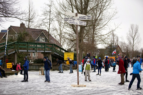 People skate in the canal near the famous bridge of Bartlehiem north of Leeuwarden.