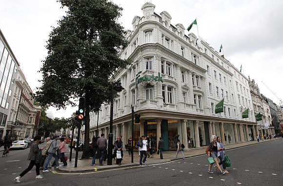 Pedestrians walk past the Fenwick department store in Bond Street in London, United Kingdom.