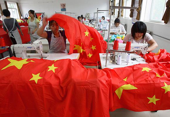 Workers sew Chinese national flags at a factory on the outskirts of Beijing.