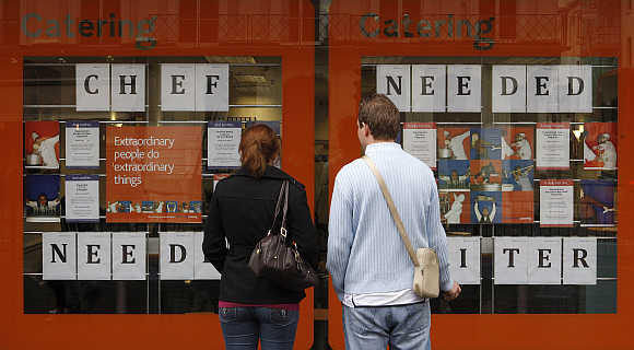 Pedestrians read recruitment announcements in central London.