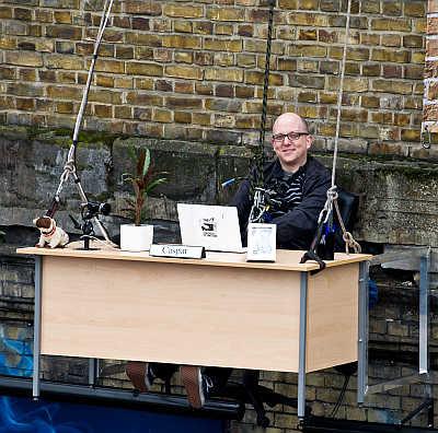 An office worker at a desk suspended outside a building at Peter The Pleater in London, United Kingdom. Taking flexible working to new heights, O2 is proving you really can work anywhere.