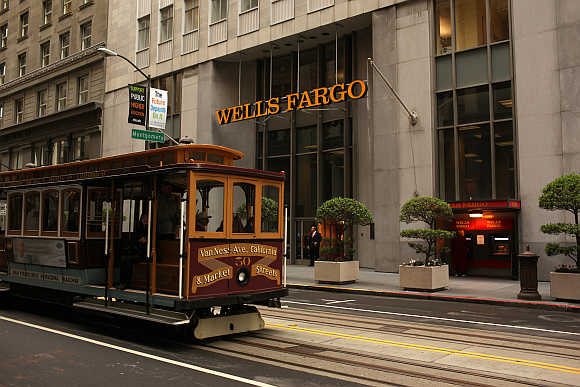 A cable car passes the Wells Fargo Bank headquarters in the Financial District in San Francisco, California.