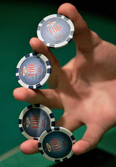 A dealer holds chips between his fingers in Budapest, Hungary.