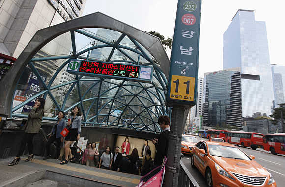 People exit a subway station in the Gangnam area of Seoul, South Korea.