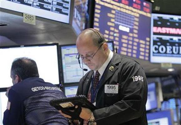 Traders work on the floor of the New York Stock Exchange.