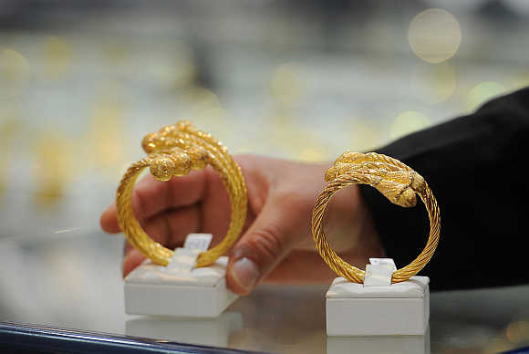 A woman looks at jewellery in a gold shop in Abu Dhabi, United Arab Emirates.