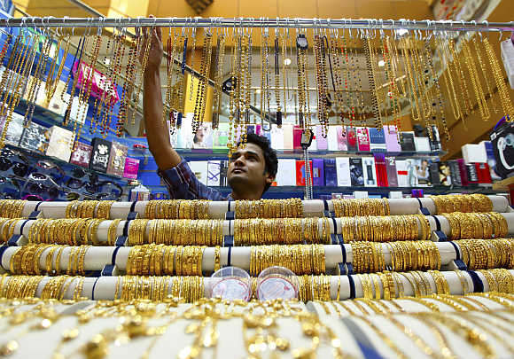 A salesman arranges jewellery at a shop at the gold souk in Dubai, United Arab Emirates.