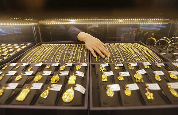 An employee arranges gold jewellery in the counter of a shop in Wuhan, Hubei province, China.