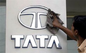A worker cleans a Tata Motors logo outside its showroom in Hyderabad. Photograph: Krishnendu Halder/Reuters